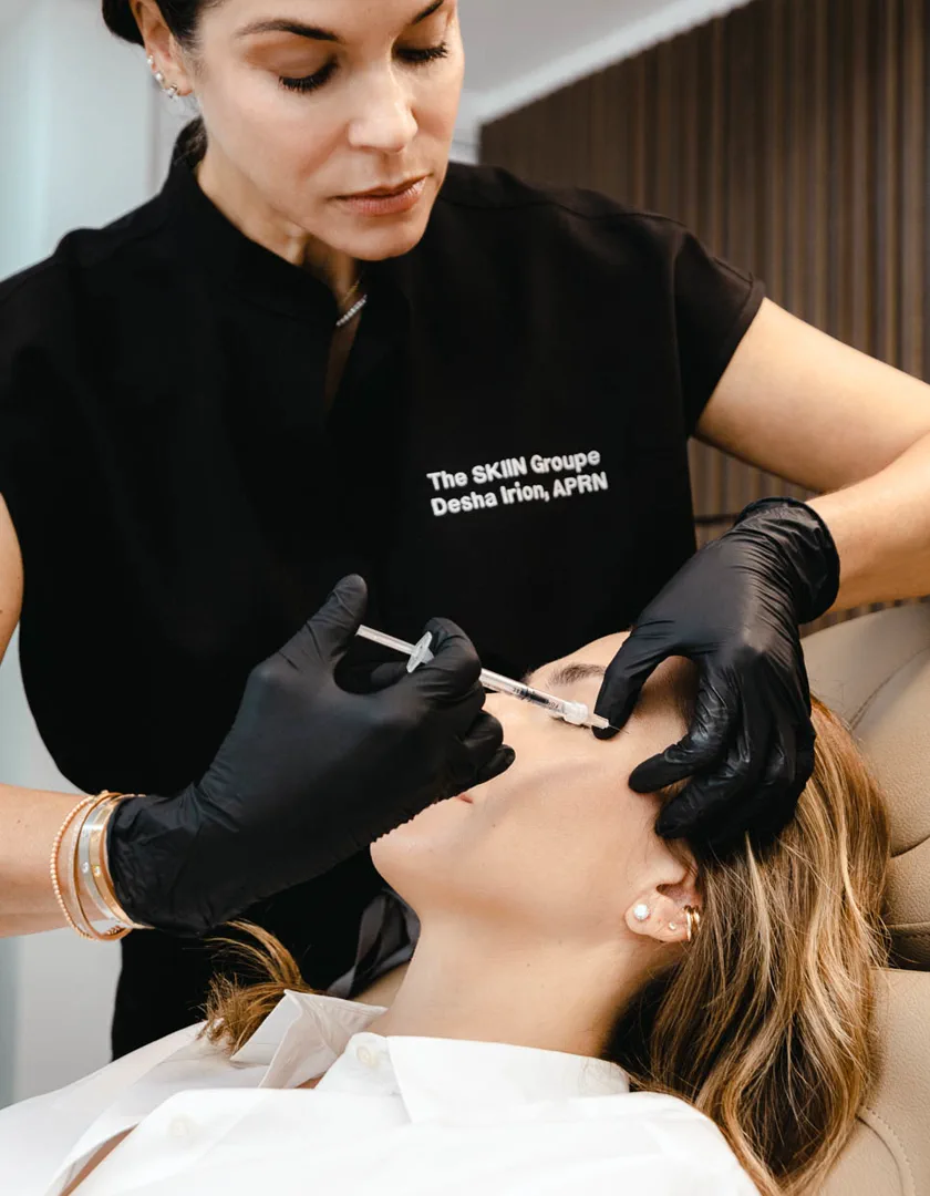 Desha Irion, APRN, administering an injectable treatment to a client at The SKIIN Groupe